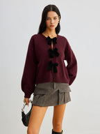 R&B | Strickcardigan mit Samtschleifen Wollmischung Feminin und Modern