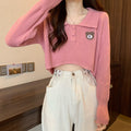Damen Cropped Pullover mit einem Knopfverschluss und Einhorn-Emblem