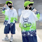 Unisex nan leichte winddichte Kapuzenjacke mit allover Grafikprint und reflektierenden Einsätzen für Kinder  R&B