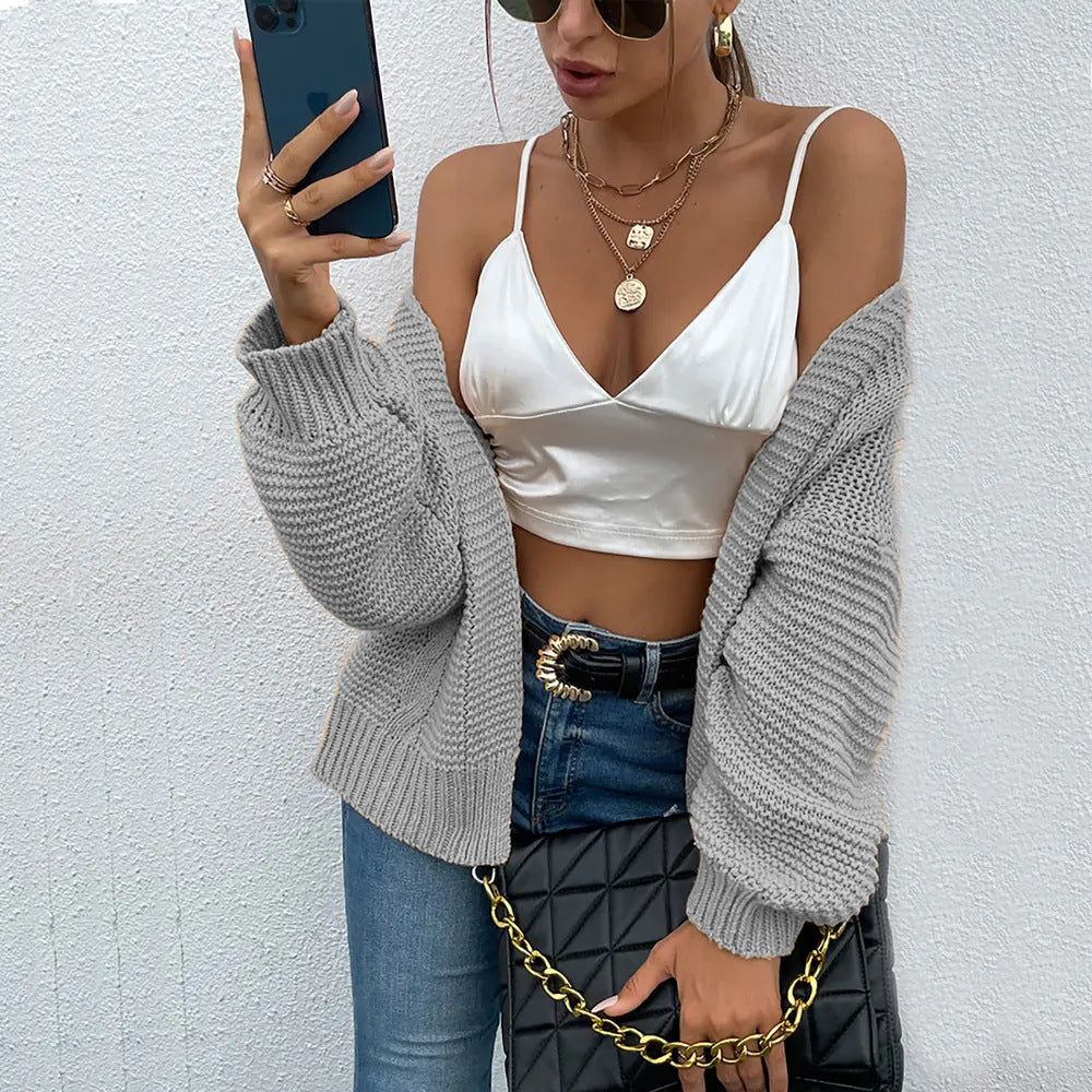Damen Strickjacke mit voluminösen Ärmel und stylischem Rippenmuster