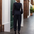 Damen Eleganter Jumpsuit mit transparenten Ärmeln und tiefem V-Ausschnitt