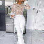 Jumpsuit mit Glitzer und Federn